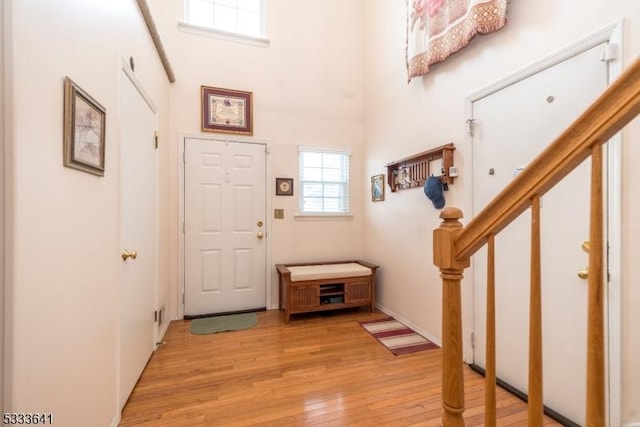 doorway with a high ceiling and light wood-type flooring