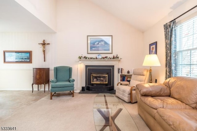 carpeted living room featuring high vaulted ceiling