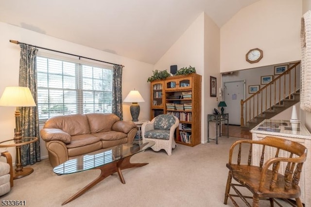 living room with carpet floors and high vaulted ceiling