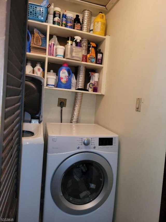 clothes washing area featuring washer and clothes dryer