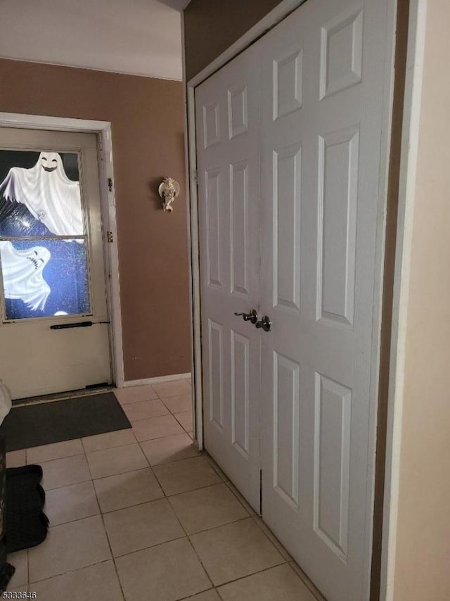 doorway to outside featuring light tile patterned flooring