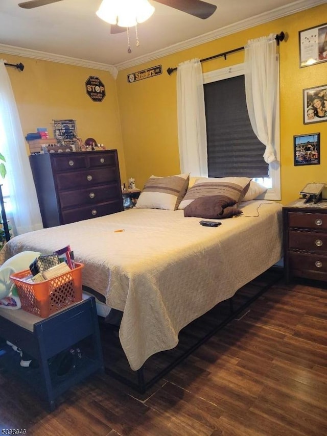 bedroom with crown molding, ceiling fan, and dark hardwood / wood-style floors