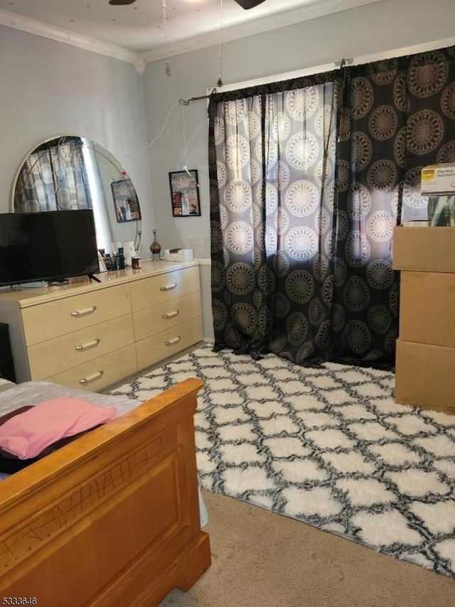 bedroom with ornamental molding and light colored carpet