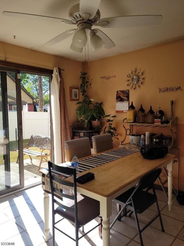 tiled dining area featuring ceiling fan