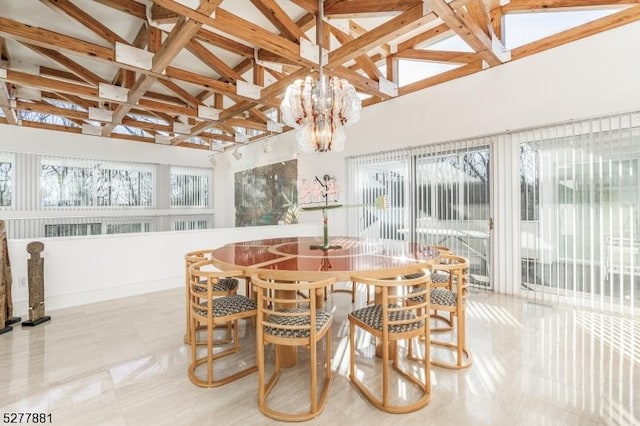 sunroom featuring a notable chandelier and vaulted ceiling