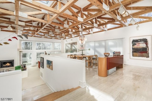 interior space featuring pendant lighting, a wealth of natural light, and high vaulted ceiling