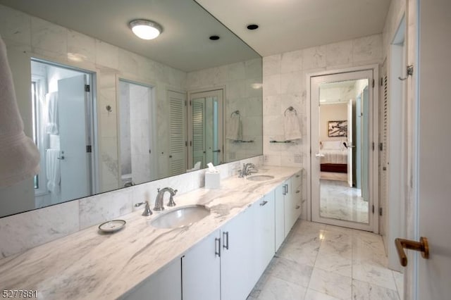 bathroom featuring tile walls and vanity