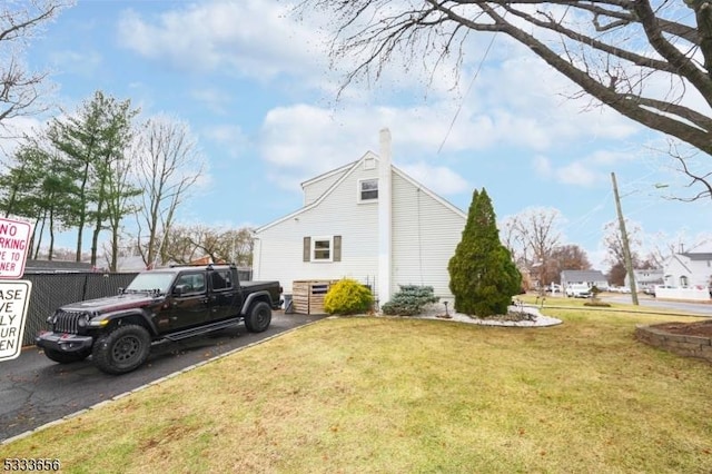 view of side of home featuring a lawn