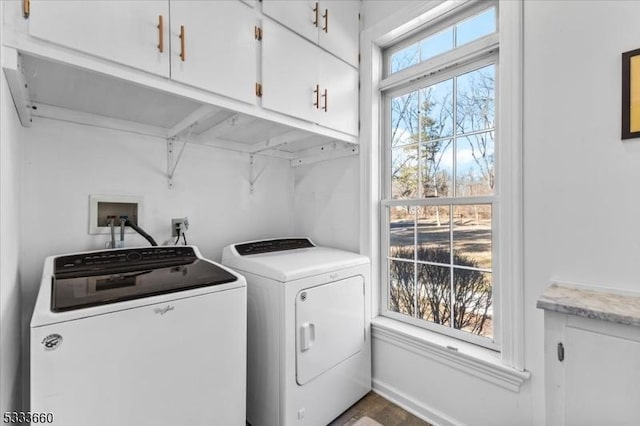 washroom featuring washing machine and dryer and cabinets