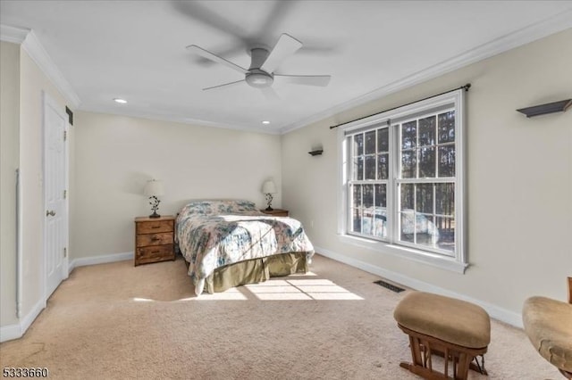 carpeted bedroom featuring crown molding and ceiling fan