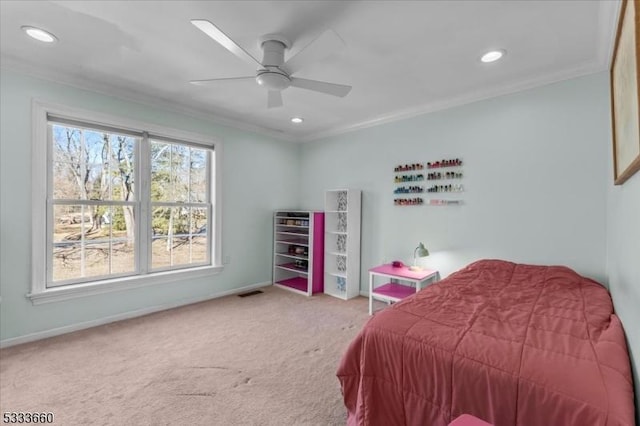 carpeted bedroom with crown molding and ceiling fan