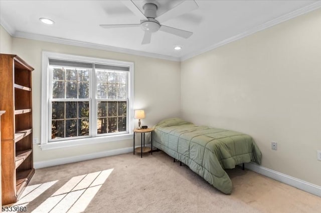 carpeted bedroom featuring ceiling fan and ornamental molding