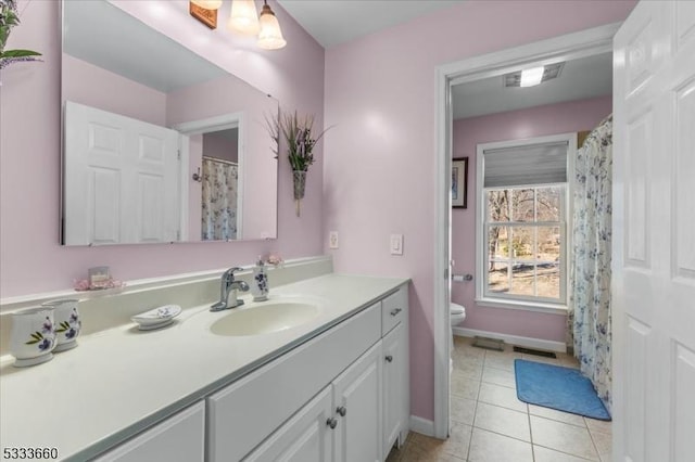 bathroom featuring vanity, tile patterned flooring, and toilet