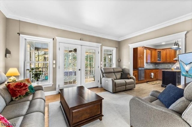 living room featuring ornamental molding, light hardwood / wood-style floors, and french doors