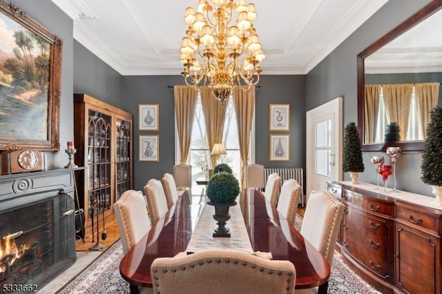 dining area with ornamental molding and a notable chandelier