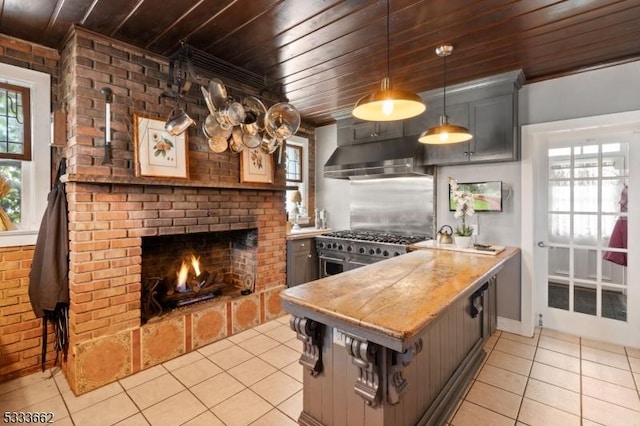 kitchen with brick wall, light tile patterned floors, wooden ceiling, and decorative light fixtures