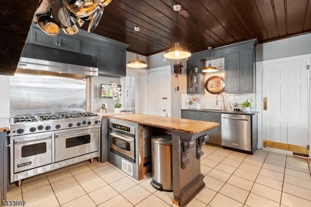 kitchen with appliances with stainless steel finishes, tasteful backsplash, hanging light fixtures, crown molding, and wooden ceiling