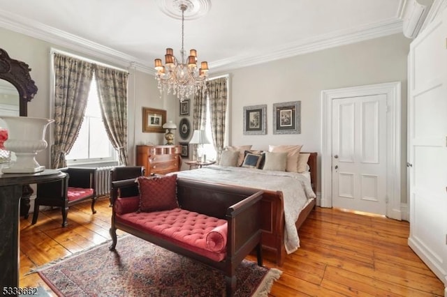 bedroom with an inviting chandelier, crown molding, and wood-type flooring