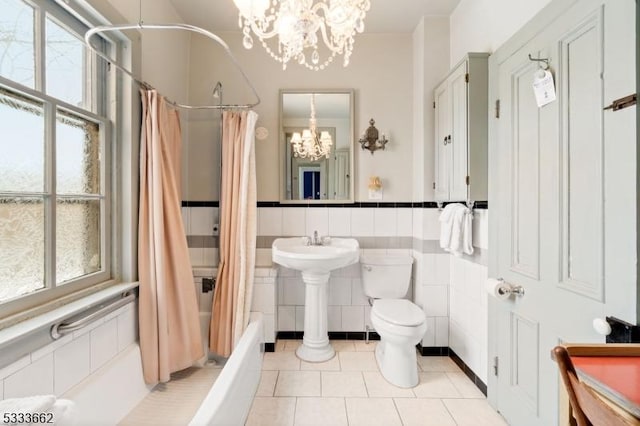 bathroom featuring tile walls, a chandelier, tile patterned flooring, toilet, and shower / bathtub combination with curtain