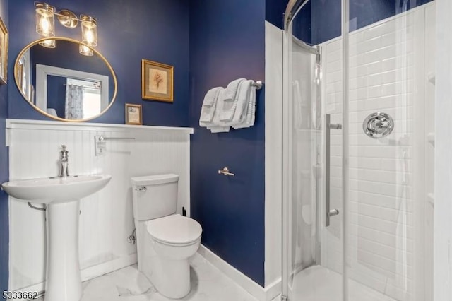 bathroom with toilet, an enclosed shower, and sink