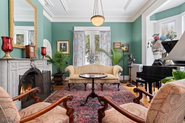 sitting room featuring hardwood / wood-style floors, ornamental molding, and french doors