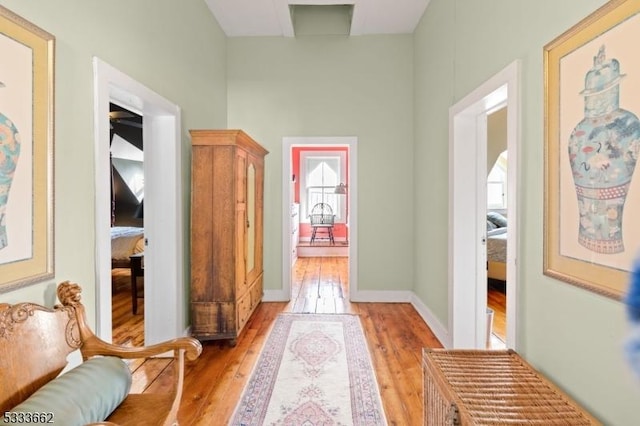 hallway with light hardwood / wood-style flooring