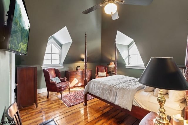 bedroom featuring multiple windows, vaulted ceiling, ceiling fan, and light hardwood / wood-style floors