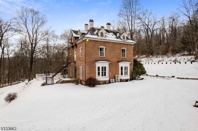 view of snow covered back of property