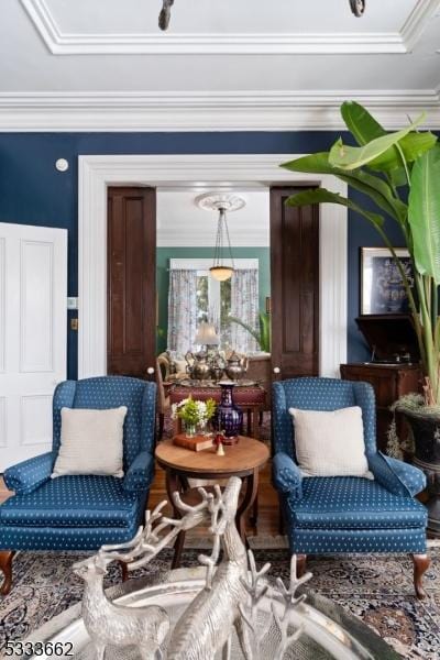 living area with crown molding