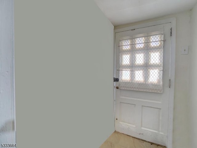 doorway featuring light tile patterned flooring