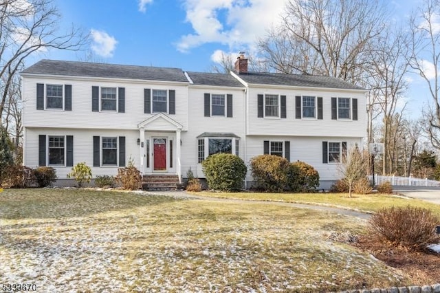 colonial inspired home with a front yard