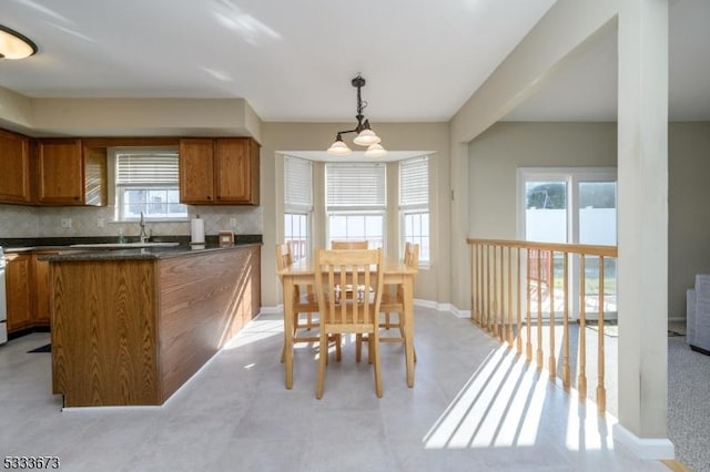 kitchen featuring pendant lighting, sink, and decorative backsplash