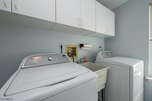 laundry room featuring cabinets and separate washer and dryer