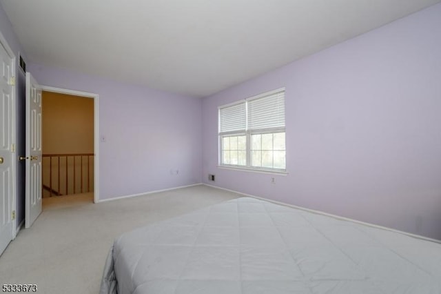 unfurnished bedroom featuring light colored carpet