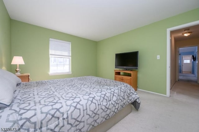 bedroom featuring light carpet