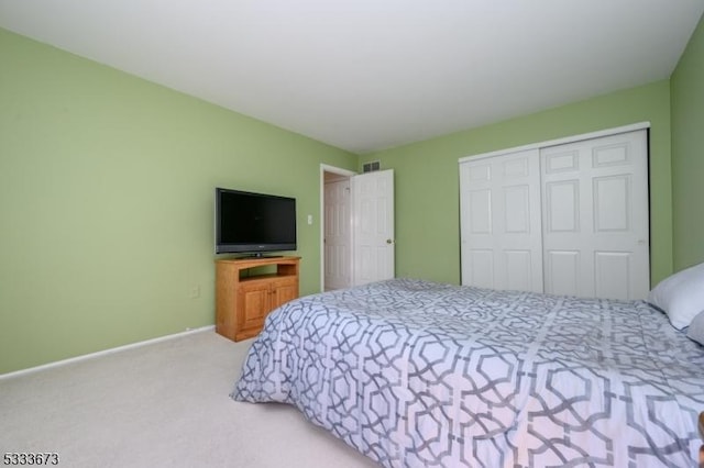 carpeted bedroom with a closet