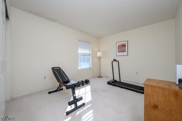 exercise room with light colored carpet