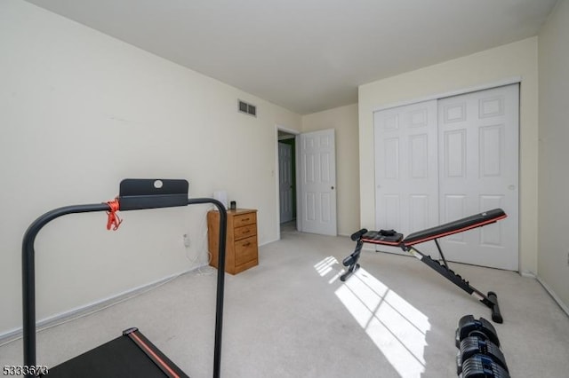 exercise room featuring light colored carpet