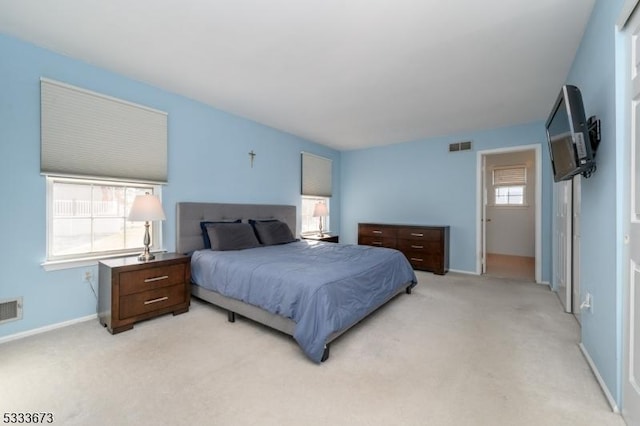 bedroom featuring light carpet