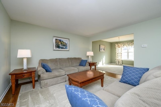 living room with hardwood / wood-style flooring and a chandelier