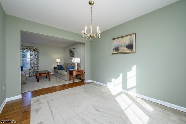 interior space featuring a notable chandelier and hardwood / wood-style flooring