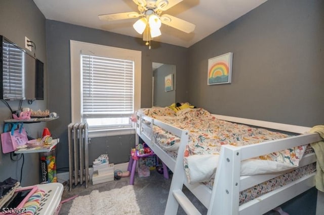 bedroom with radiator heating unit and ceiling fan