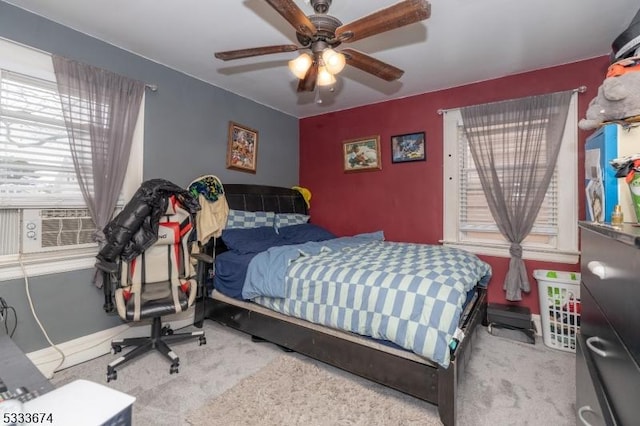 carpeted bedroom with cooling unit and ceiling fan