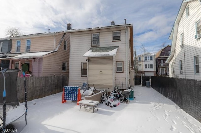 view of snow covered back of property