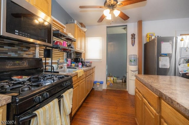 kitchen with light brown cabinetry, ceiling fan, sink, dark wood-type flooring, and stainless steel appliances