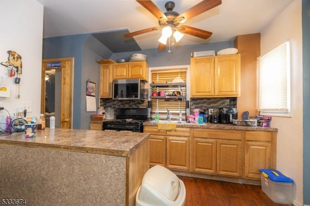 kitchen with light brown cabinets, sink, black gas range, dark hardwood / wood-style floors, and decorative backsplash