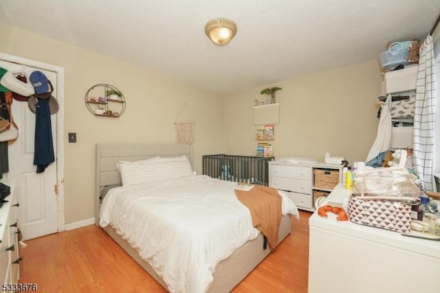 bedroom featuring light wood-type flooring and baseboards