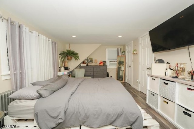 bedroom with recessed lighting and wood finished floors