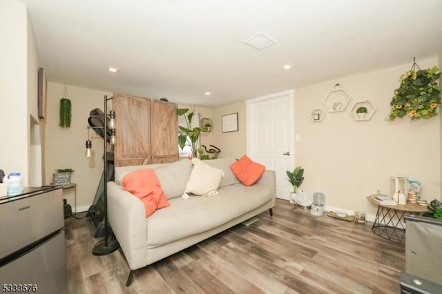 living room with recessed lighting and wood finished floors