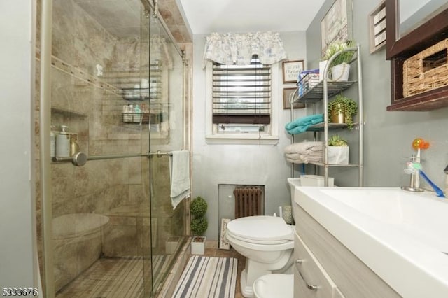 full bathroom with toilet, a stall shower, vanity, and radiator heating unit